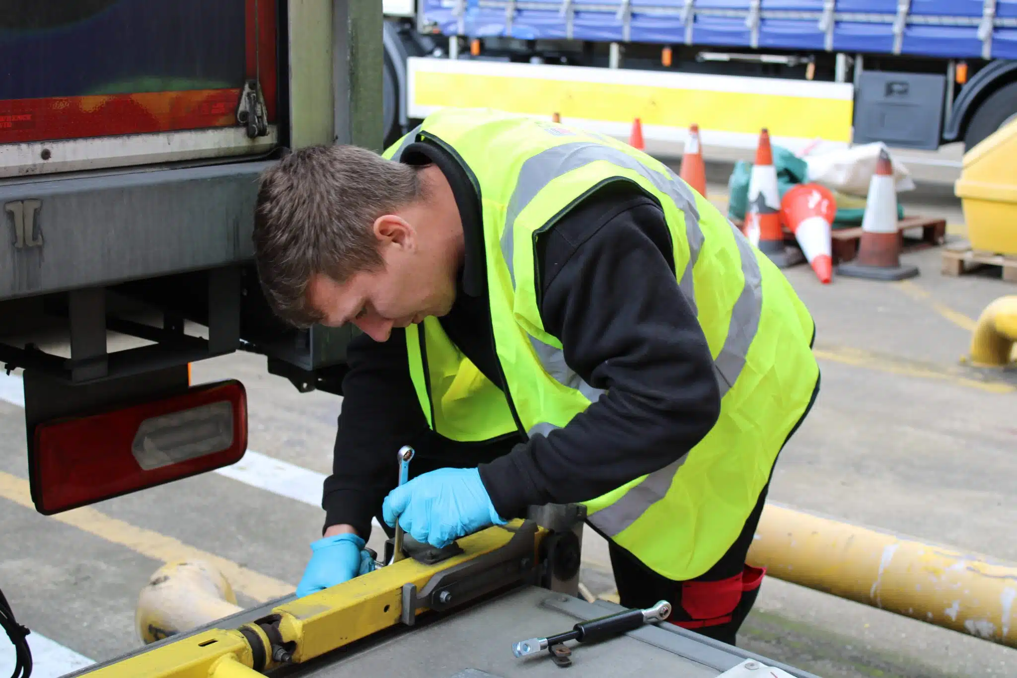Engineer carrying out maintenance checks on a commercial vehicle tail lift